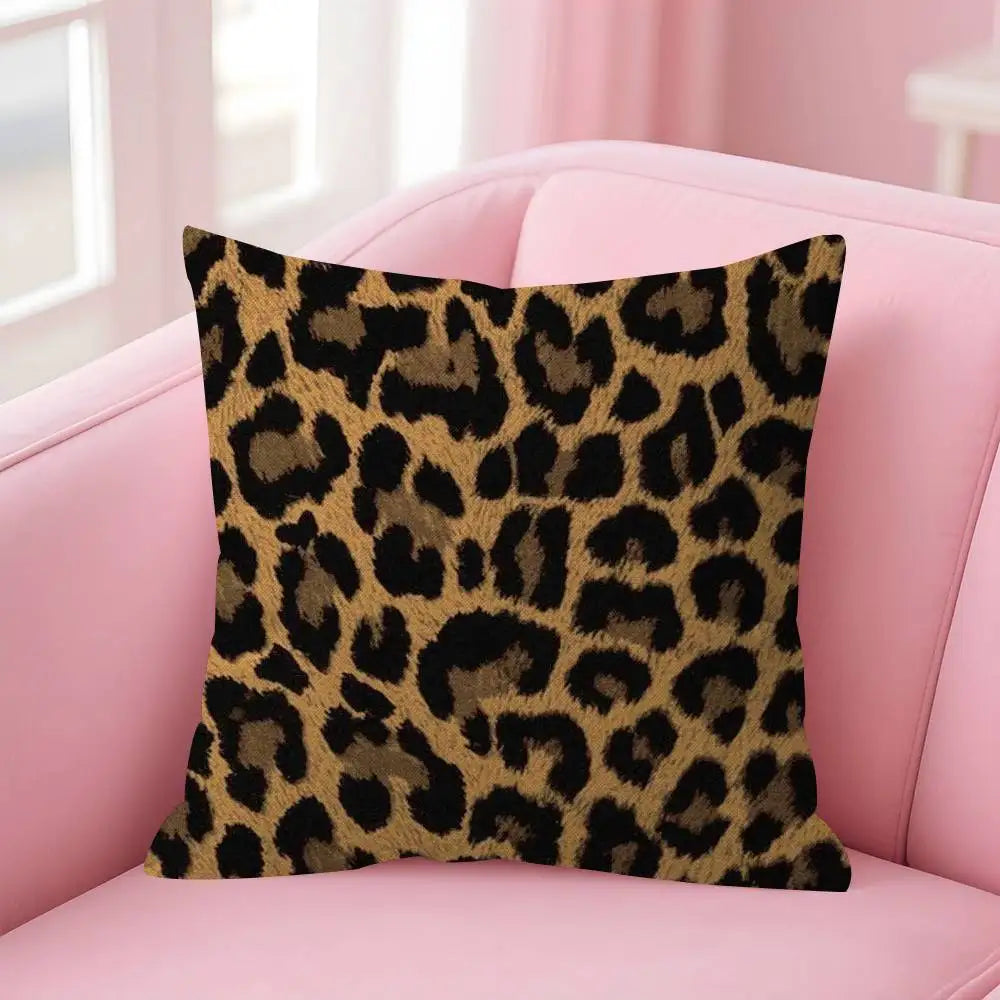A square decorative pillow cover with a brown and black leopard print fabric resting on a pink sofa.