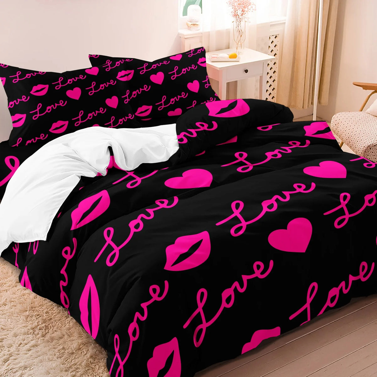 Black duvet cover featuring a pink love print with hearts and lips on a white background.