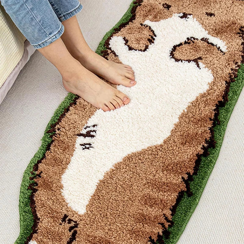A brown and white decorative cat mat is shown with a person's foot resting on it.