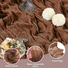 Boho brown cheesecloth fabric draped on a surface with decorative elements and a gold object.
