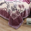 A plush mink fleece king size blanket featuring a floral pattern with shades of rose and peony on a light background.