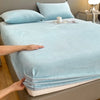 A light blue luxury velvet bedding set featuring a sheet and pillow, shown on a bed.