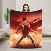 A football player in a red jersey stands against a dramatic sunset backdrop on a throw blanket.