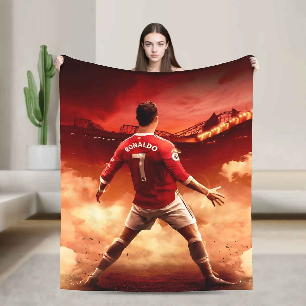 A football player in a red jersey stands against a dramatic sunset backdrop on a throw blanket.