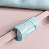 Light blue non-slip bed sheet grippers with heart-shaped clips shown on a pink fabric.