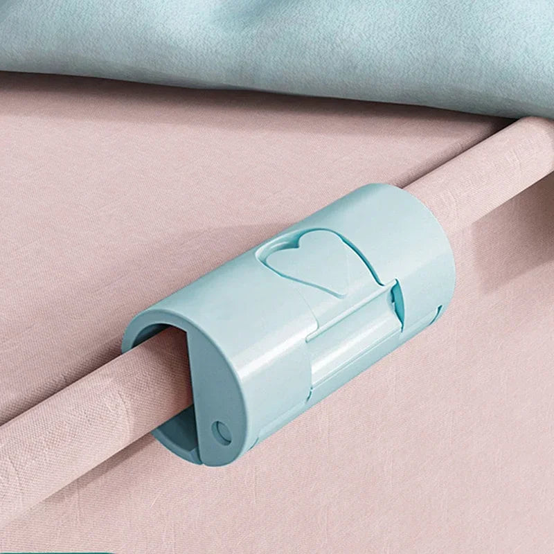 Light blue non-slip bed sheet grippers with heart-shaped clips shown on a pink fabric.