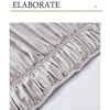 Close-up of a silver satin ruffled bed skirt fabric detail.