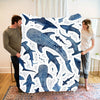 A plush blanket featuring a watercolor pattern of various whale sharks in shades of blue and white.