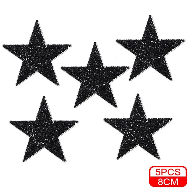 Five black glitter star shaped iron-on patches for clothing