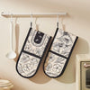 Two floral heat-resistant oven mitts are hanging on a rack against a beige wall.