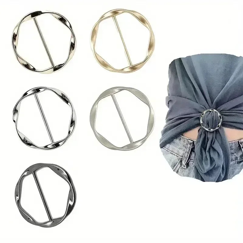 Various metal round clip buckles shown in different finishes and angles against a gray fabric background.