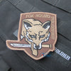 A tan embroidered patch featuring a fox head design with the text FOX HOUND and SPECIAL FORCES GROUP on a dark uniform backgr