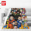 A colorful anime character flannel throw blanket draped over a light gray sofa.