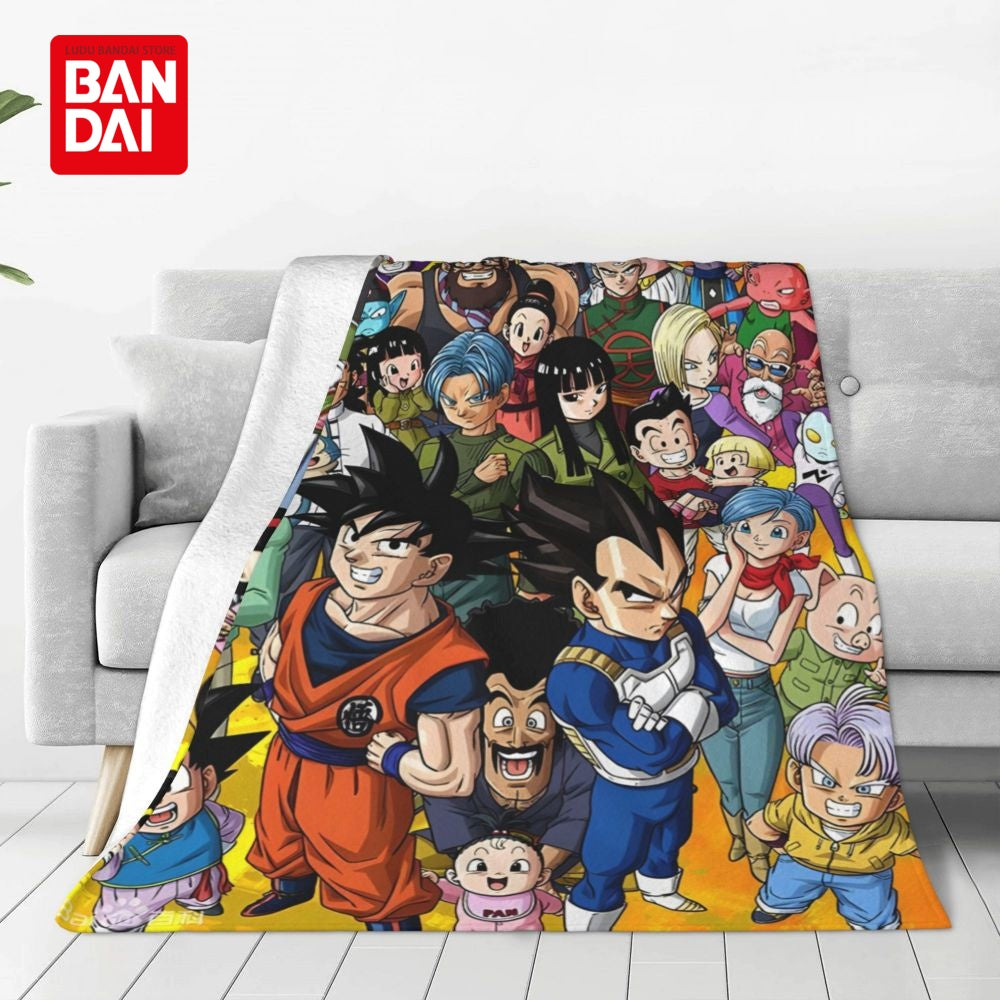 A colorful anime character flannel throw blanket draped over a light gray sofa.