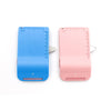 A blue and pink magnetic seam guide with a stitch gauge for sewing.