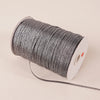 A roll of 10-meter gold and silver glitter satin ribbon with a white core and black thread.
