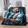 A dark blue and black graphic blanket featuring a portrait of a bearded man in a sports jersey.
