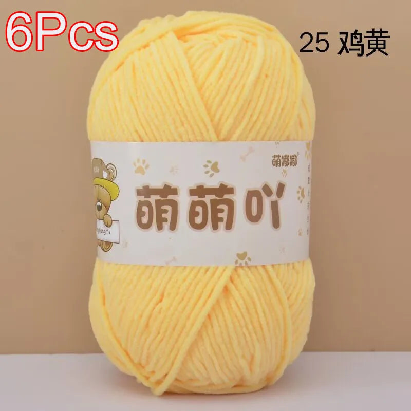 A ball of bright yellow soft bulky chenille yarn labeled as 25 balls for crochet and knitting.