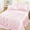 A set of two pink ruffled satin pillowcases with silky envelope closures displayed on a bed.