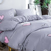 Gray bedding set featuring pink heart print duvet cover and pillowcases