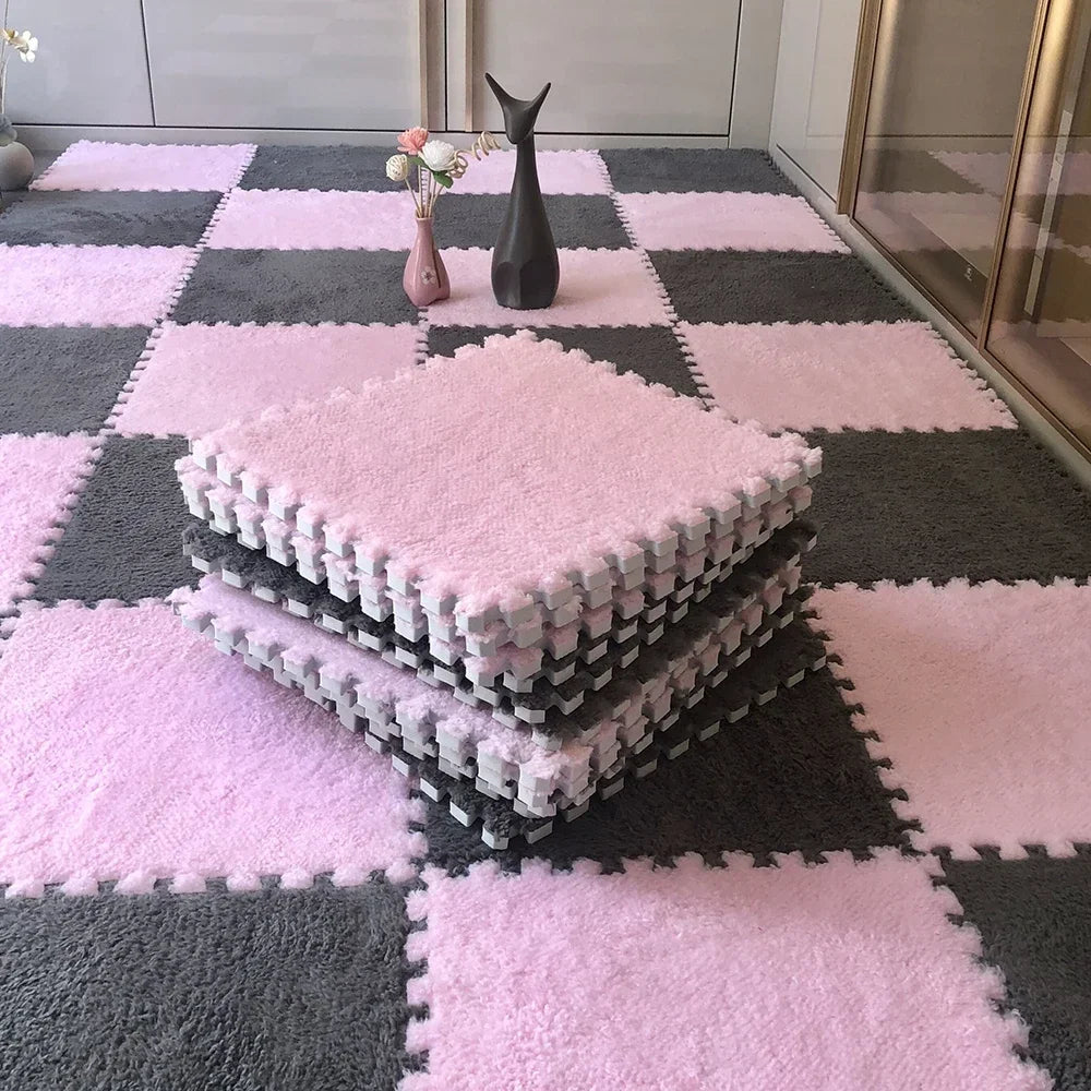 A pink and gray checkered floor mat with stacked pink plush tiles and a black decorative figurine.