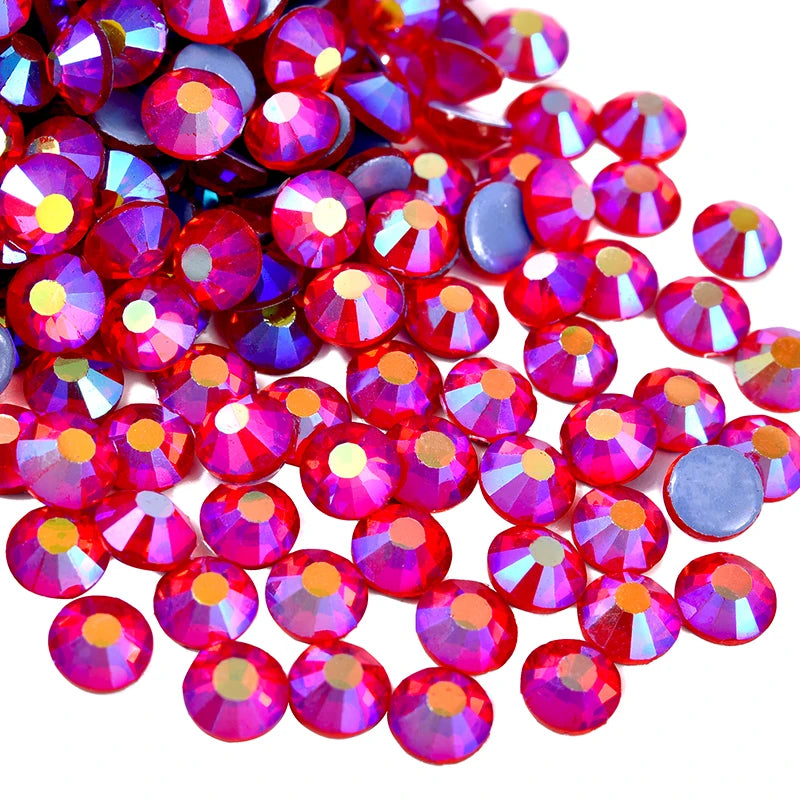 A close-up view of numerous flatback glass rhinestones in shades of pink and purple.