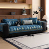 A dark blue sofa with a Christmas deer pattern mat cover sits in a modern living room.