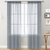 Gray sheer curtain panels with a rod pocket hanging in front of a white window.