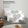 White pillowcases featuring a gray heart pattern and a black leopard print design.