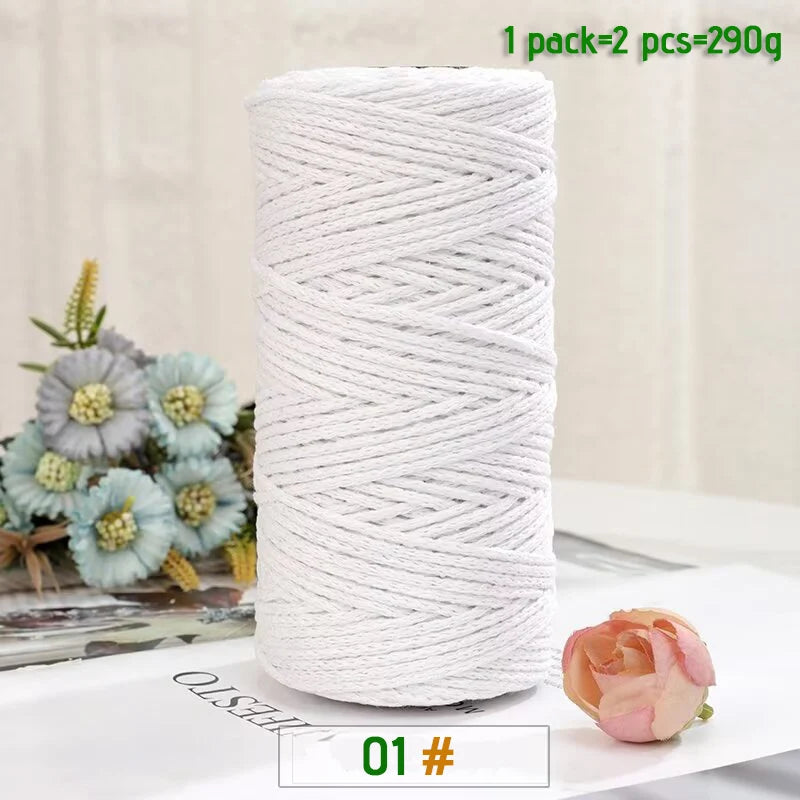 A roll of white medium-thick hand-woven cotton yarn for crafting, with a single rose placed nearby.