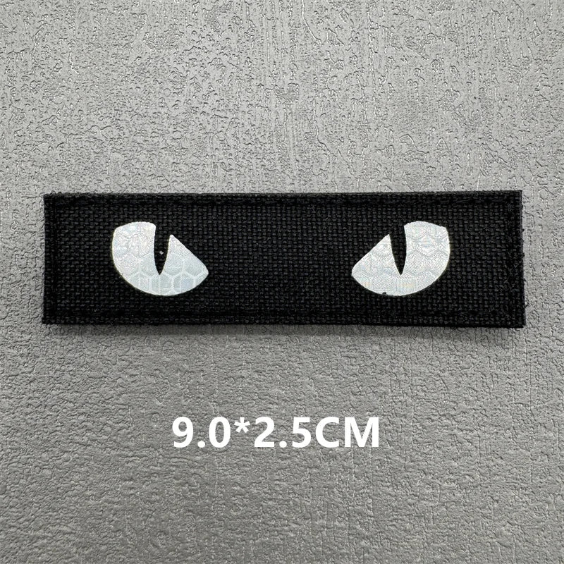 A pair of black 3D tactical IR reflective patches for clothing, showing the size measurement 9.0x2.5cm.