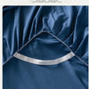 A close-up of a navy blue fabric with a silver elastic band used for fixing the bed well.