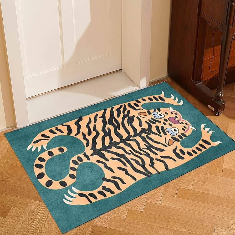 A teal rug featuring a stylized orange and black tiger with tropical palm leaf accents on a wooden floor.