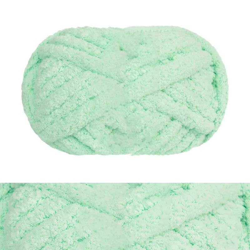 A ball of light mint green hand-knitted wool finger line scarf yarn.