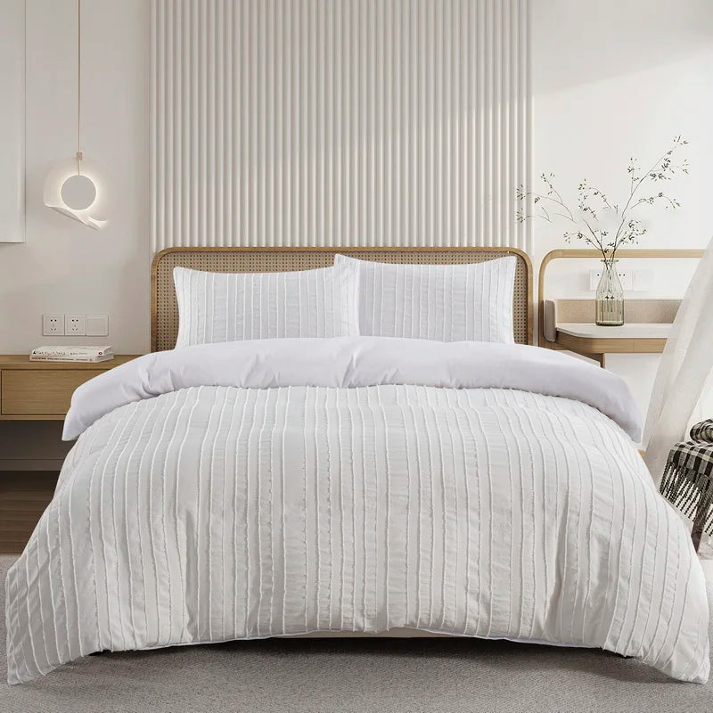 A white tufted microfiber duvet cover set displayed on a bed with a light wood frame and vertical slat headboard.