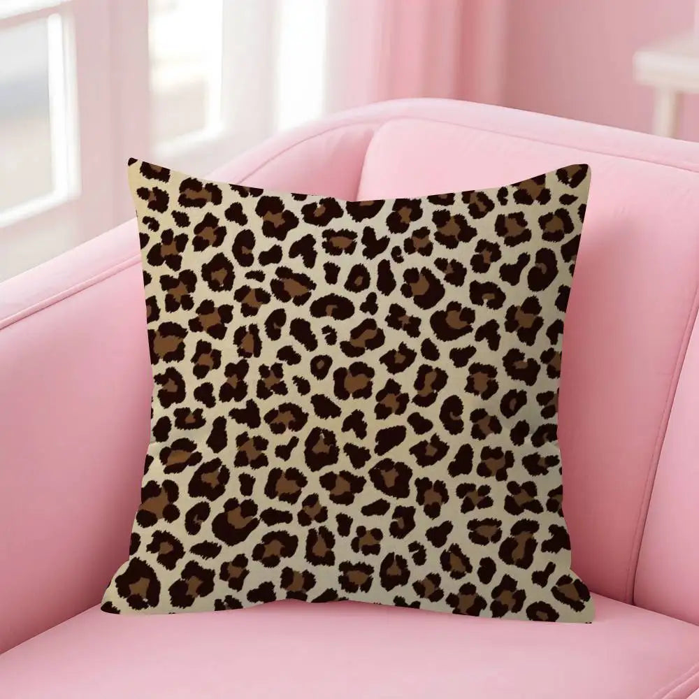 A square decorative pillow cover with a brown and black leopard print fabric resting on a pink sofa.