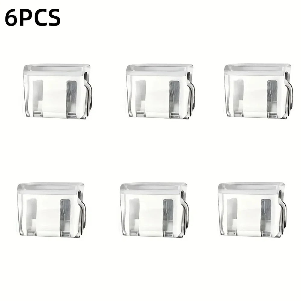Six clear plastic invisible pant hem clips used for non-slip trouser adjustment.