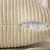 A close-up view of a beige corduroy throw pillow cover with vertical ribbed texture and a slit opening.