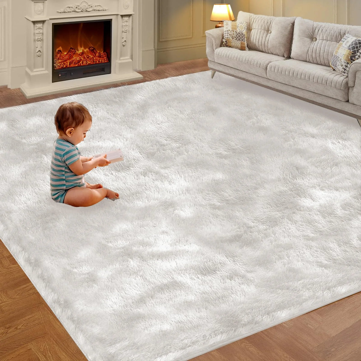 A baby is sitting on a fluffy white rug in a living room with a fireplace and sofa.