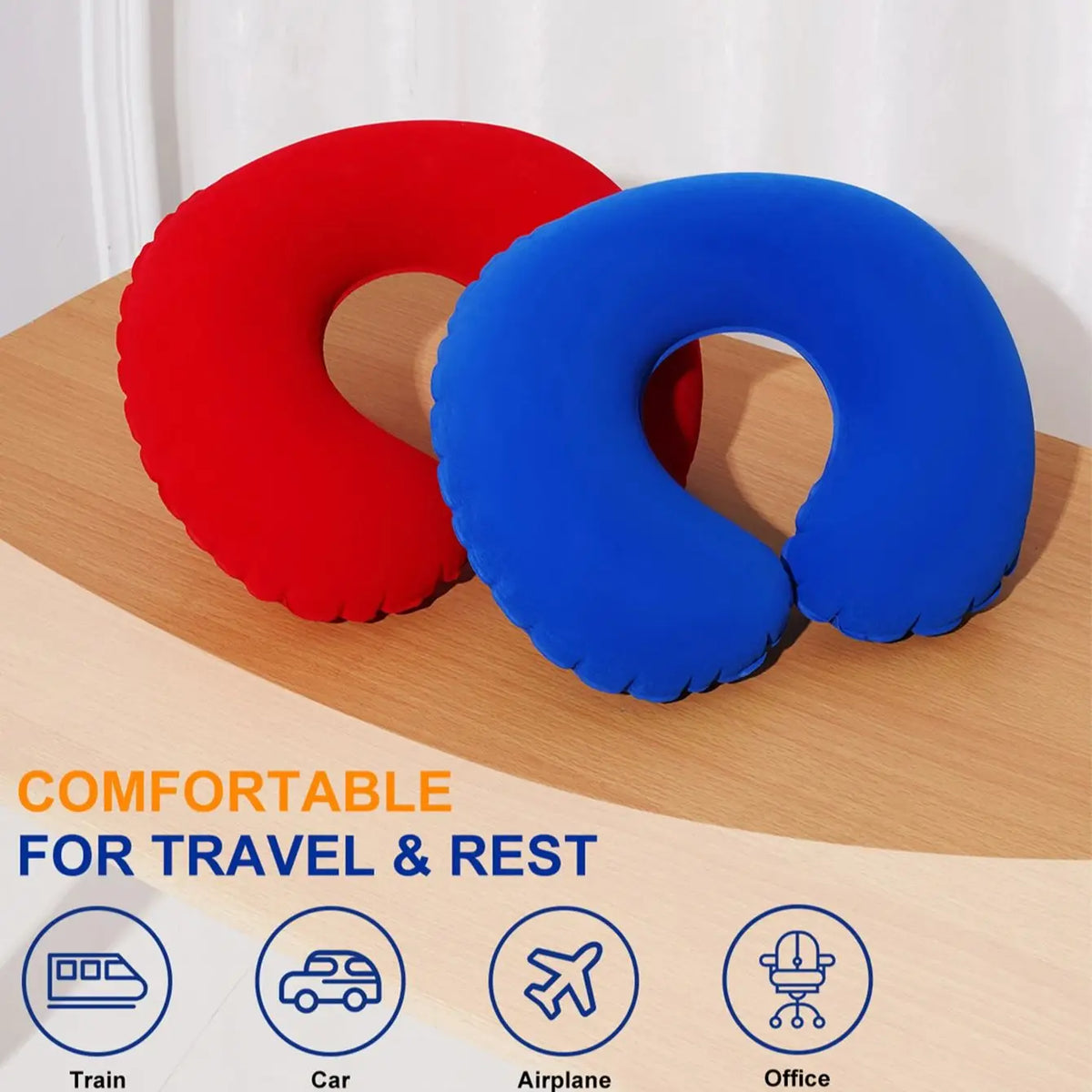 Two inflatable U-shaped travel pillows in red and blue resting on a wooden surface.