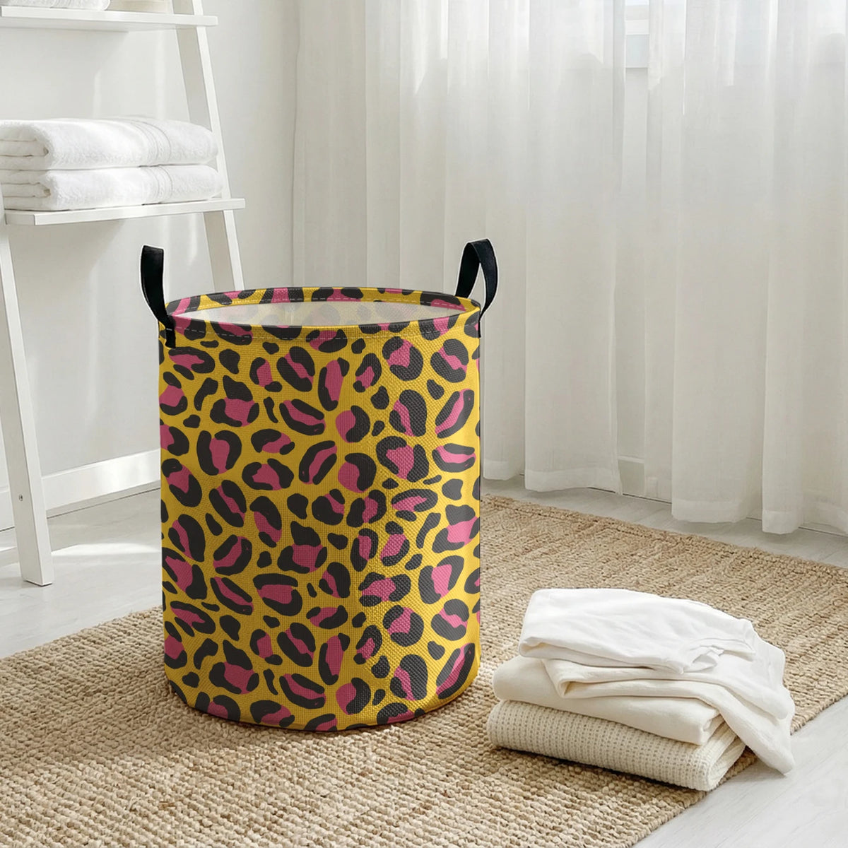 A yellow and black leopard print foldable laundry basket sitting on a woven rug near a window.
