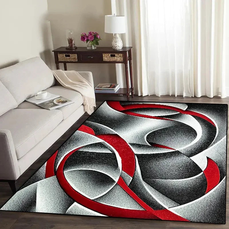 Abstract geometric area rug featuring swirling red and gray patterns on a dark floor.
