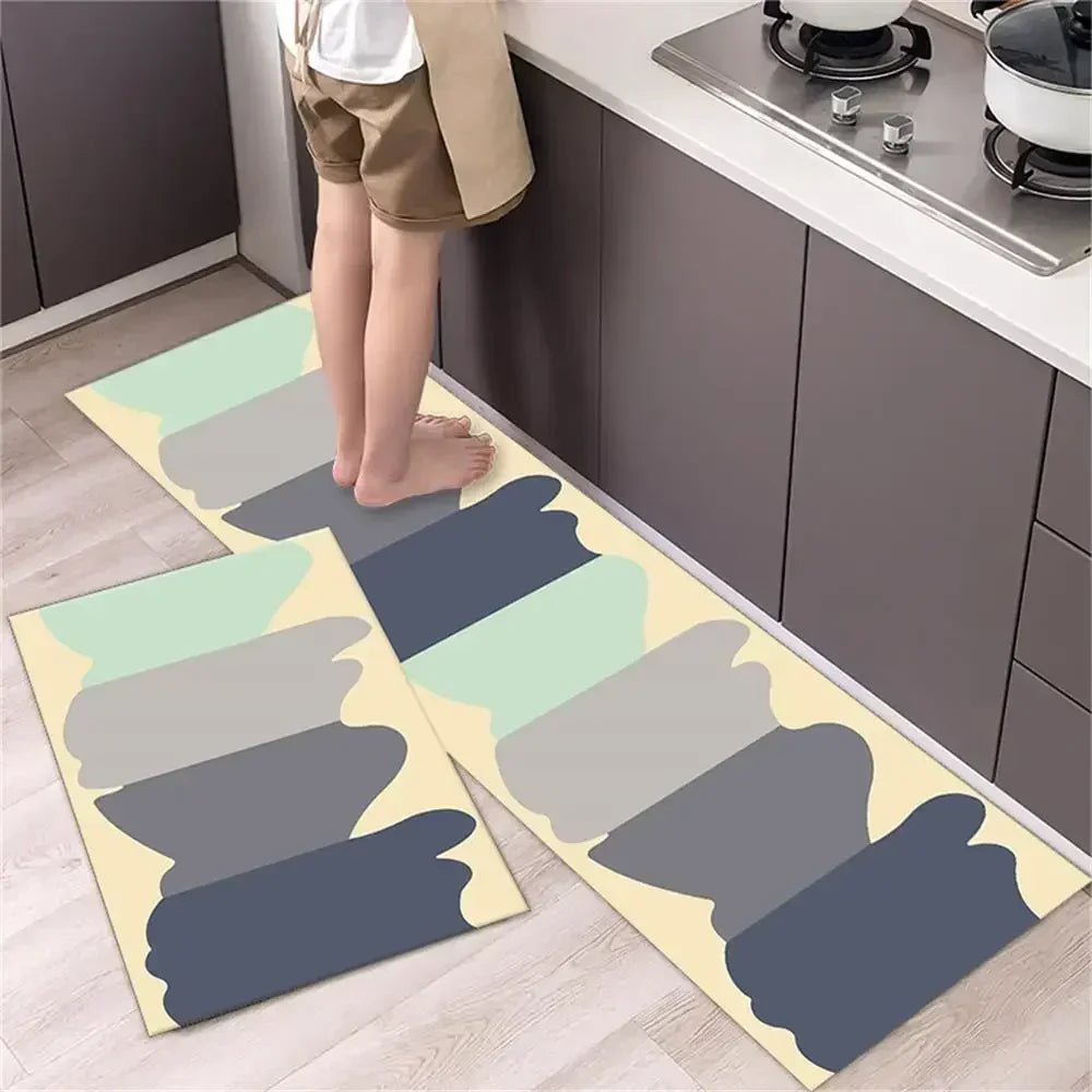 A set of two non-slip waterproof kitchen rugs with a diamond print laid out on a light wood floor.