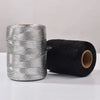 Rolls of glitter metallic yarn in silver and black for crafting projects