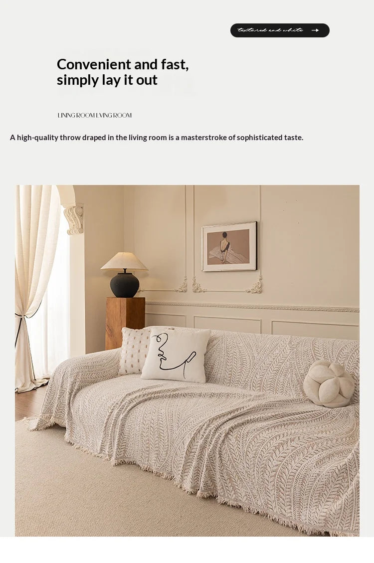 A beige herringbone chenille sofa cover draped elegantly in a living room setting.