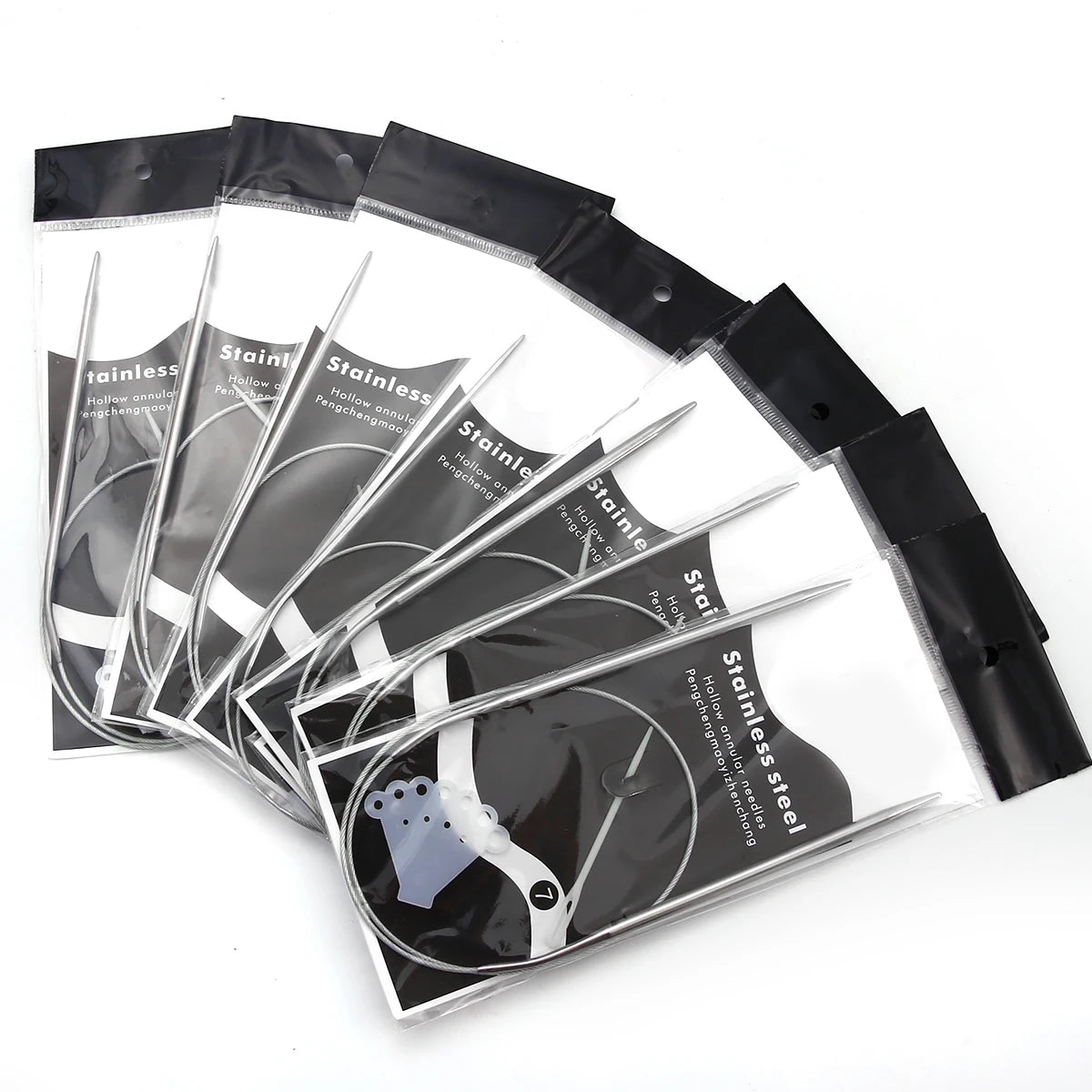 A set of stainless steel circular knitting needles packaged in clear plastic sleeves.