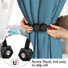 Hands adjusting a blue patterned curtain using black decorative tiebacks with magnetic rope.