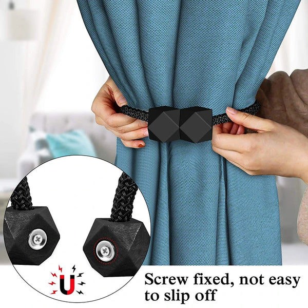 Hands adjusting a blue patterned curtain using black decorative tiebacks with magnetic rope.