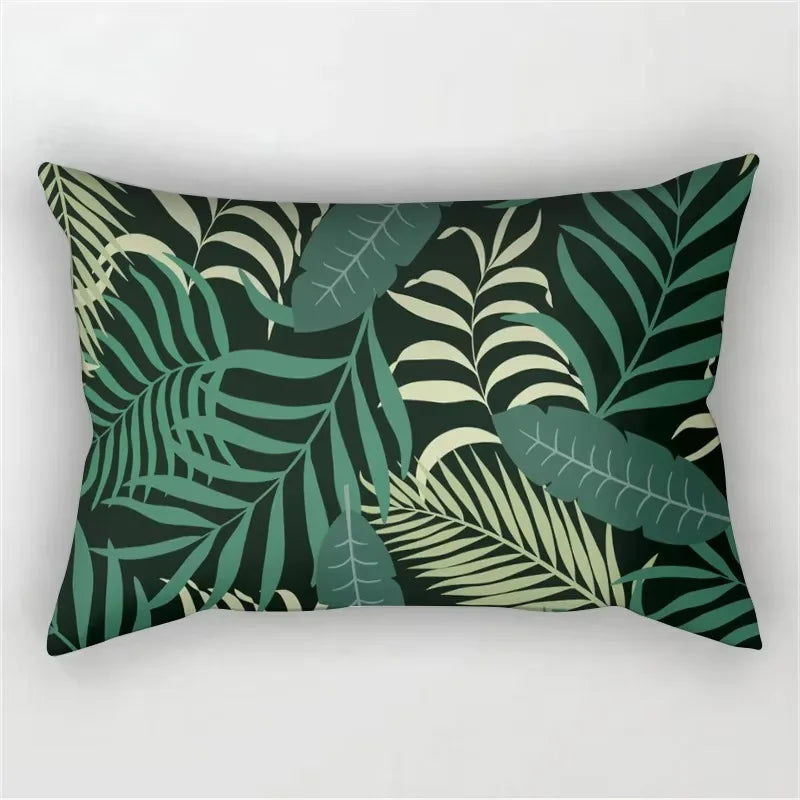 A dark green tropical leaf print pillowcase featuring various shades of green and olive on a black background.