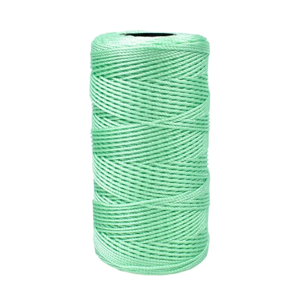 A spool of light green 1.5mm cotton silk thread for knitting and crafting.